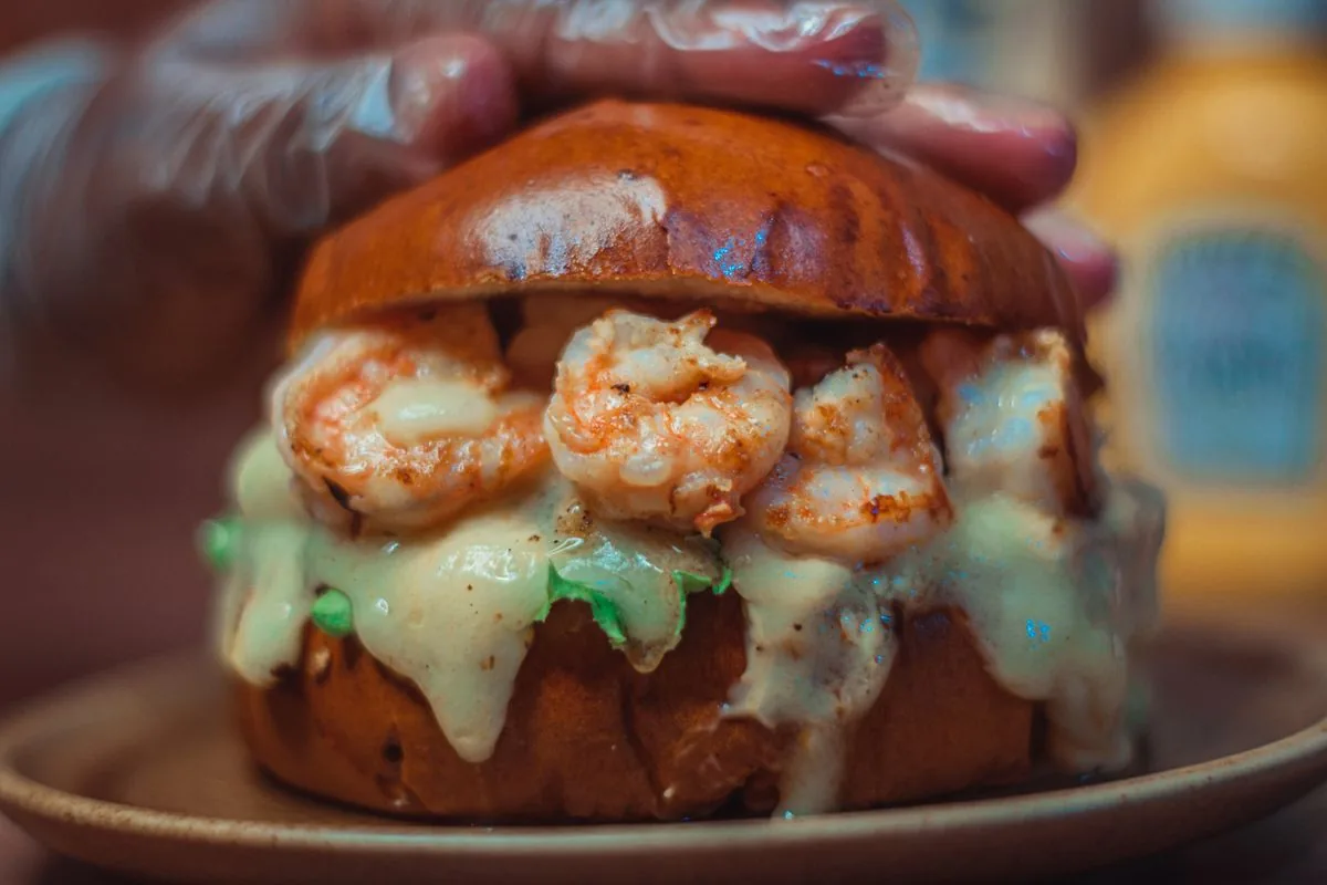 Fried shrimp po'boy piled into a soft brioche roll